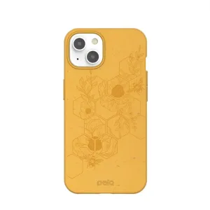 Pela Classic Hive Edition Honey iPhone 13-skal med gult bi- och blommönster på en prickig yta