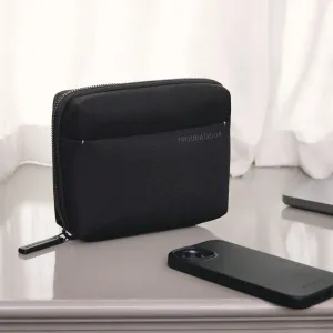 Svart fodral med dragkedja och ett smartphonefodral framför på en ljus bordsskiva