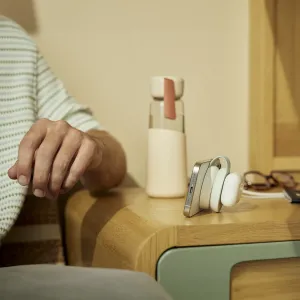 Twelve South ButterFly SE 2-i-1 Qi2-laddare hopfälld i upprätt läge med iPhone och AirPods-fodral anslutna