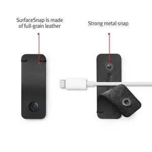 Twelve South CableSnap Stay sujetacables autoadhesivo en cuero negro, mostrado con un cable de carga.