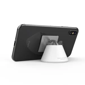 Soporte para smartphone iRing Dock con un iPhone negro y un soporte circular sobre un fondo blanco de estudio