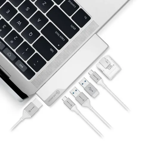 ALOGIC Ultra USB-C Dock NANO Gen 2 junto a un portátil con cables USB y tarjetas de memoria sobre una superficie blanca